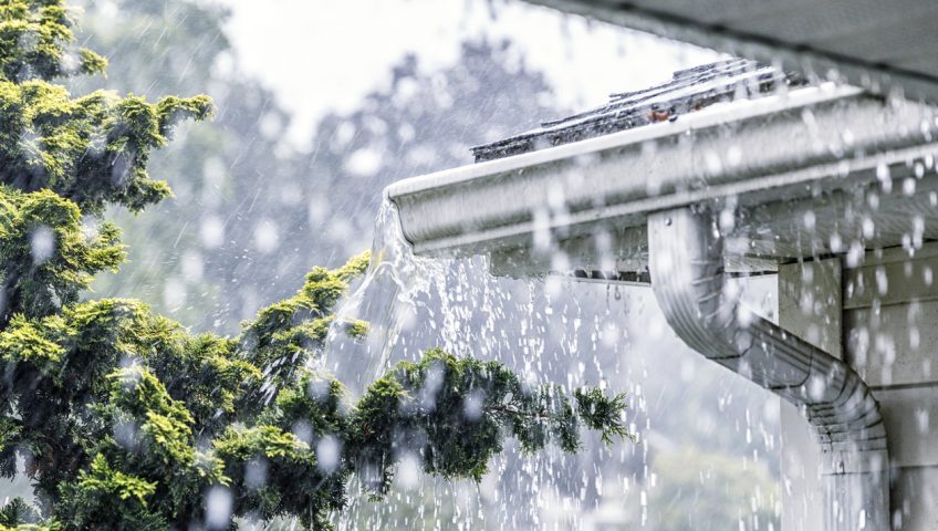 Torrential Summer Rain Storm Water Overflowing Roof Gutters