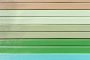 Multicolored vinyl siding with simulated wood texture. Plastic wall covering for exterior decoration of house. Abstract background for your design